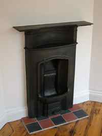 bedroom fireplace with hearth tiling in Brighton