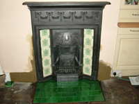Fireplace hearth tiled in reproduction green Edwardian tiles from Twentieth Century Fires Ltd