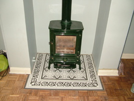 enamelled stovax stove on a tiled hearth