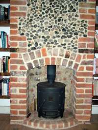 machine mart barrel wood burner in rebuilt flint fireplace in Brighton